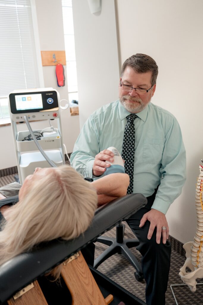 Dr Jason treating patient's shoulder injury