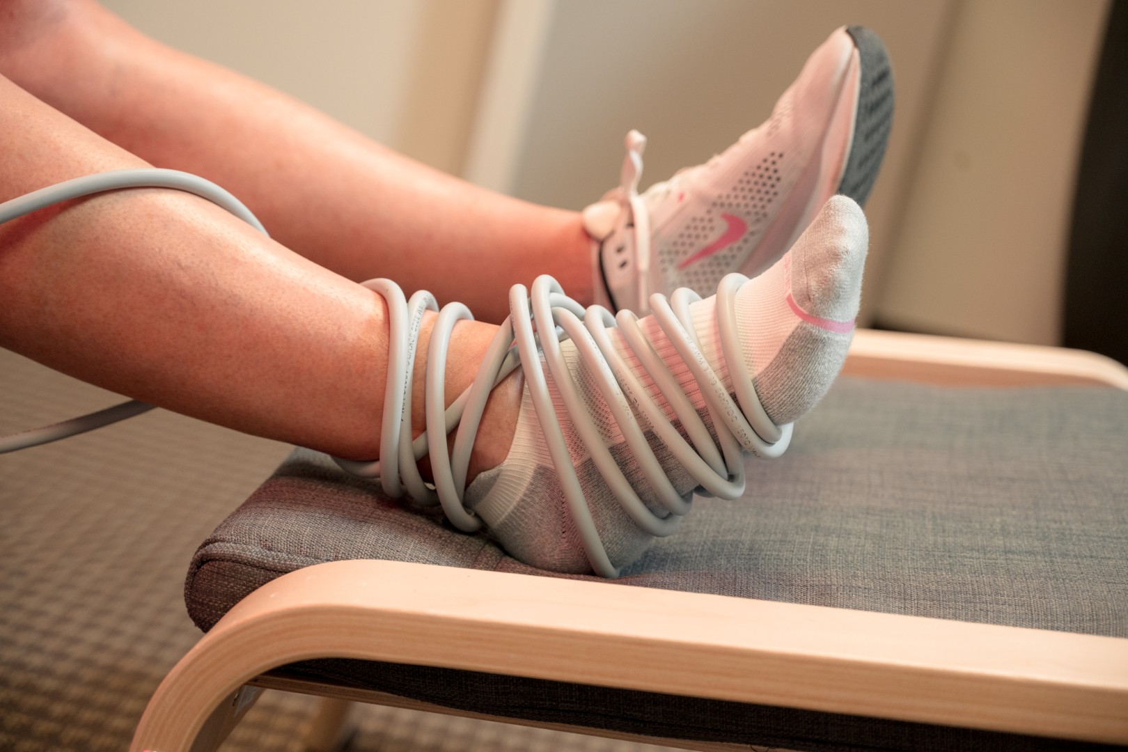 Close-up of a PEMF coil applicator easing ankle pain.